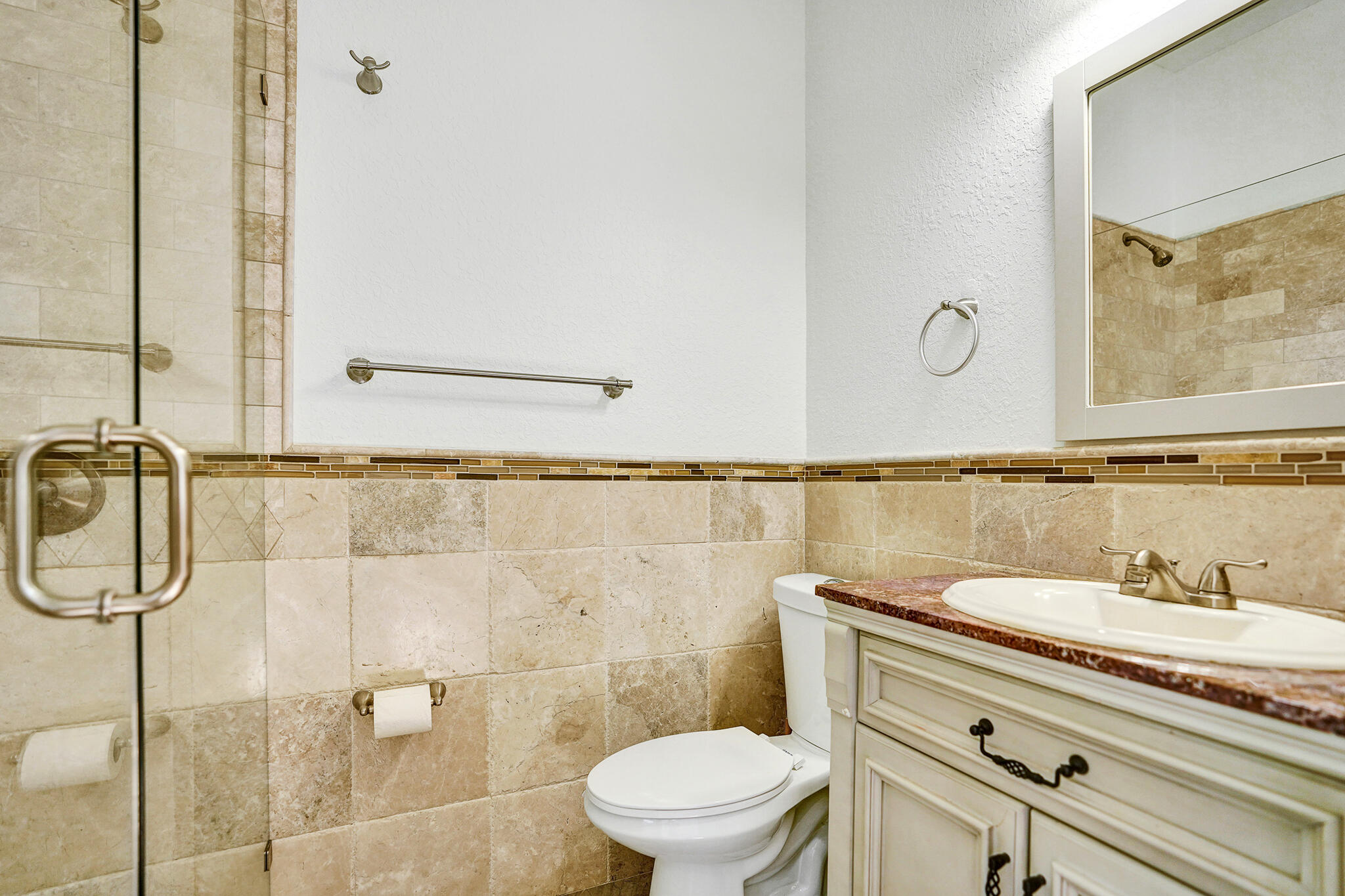 785 Northeast 71st Street Boca Raton, FL 33487 - Photo 34 of 62 a bathroom with a granite countertop sink a toilet and a mirror