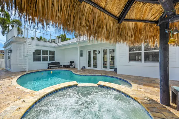 a view of a house with a swimming pool outdoor seating