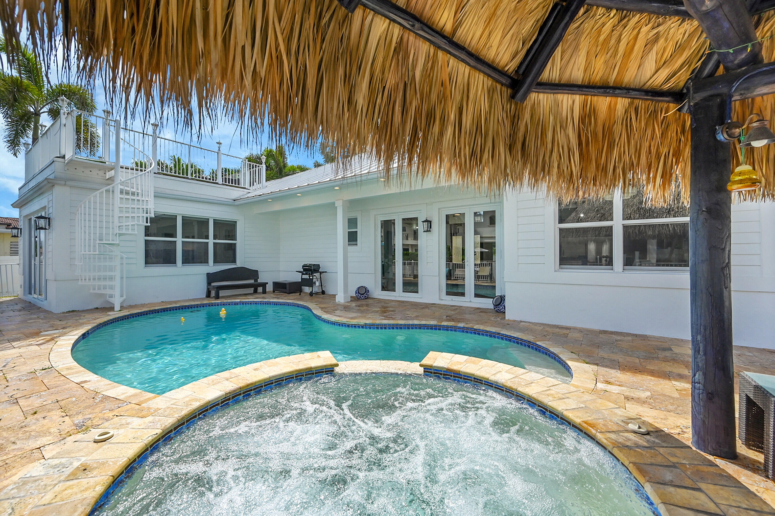 785 Northeast 71st Street Boca Raton, FL 33487 - Photo 40 of 62 a view of a house with swimming pool and porch