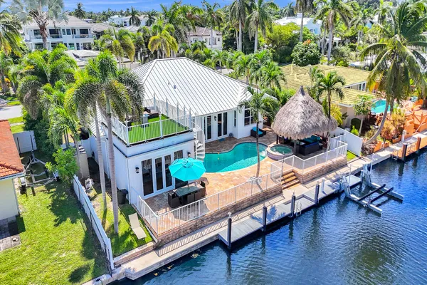 a aerial view of a house with a yard and potted plants