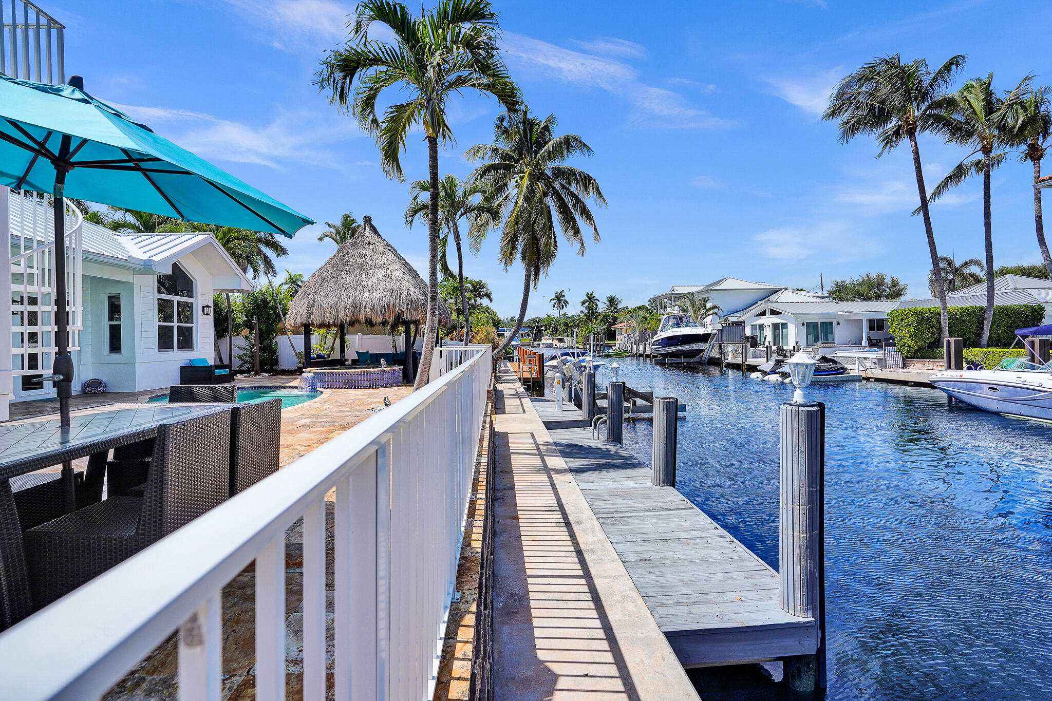 785 Northeast 71st Street Boca Raton, FL 33487 - Photo 52 of 62 a swimming pool with outdoor seating and a garden