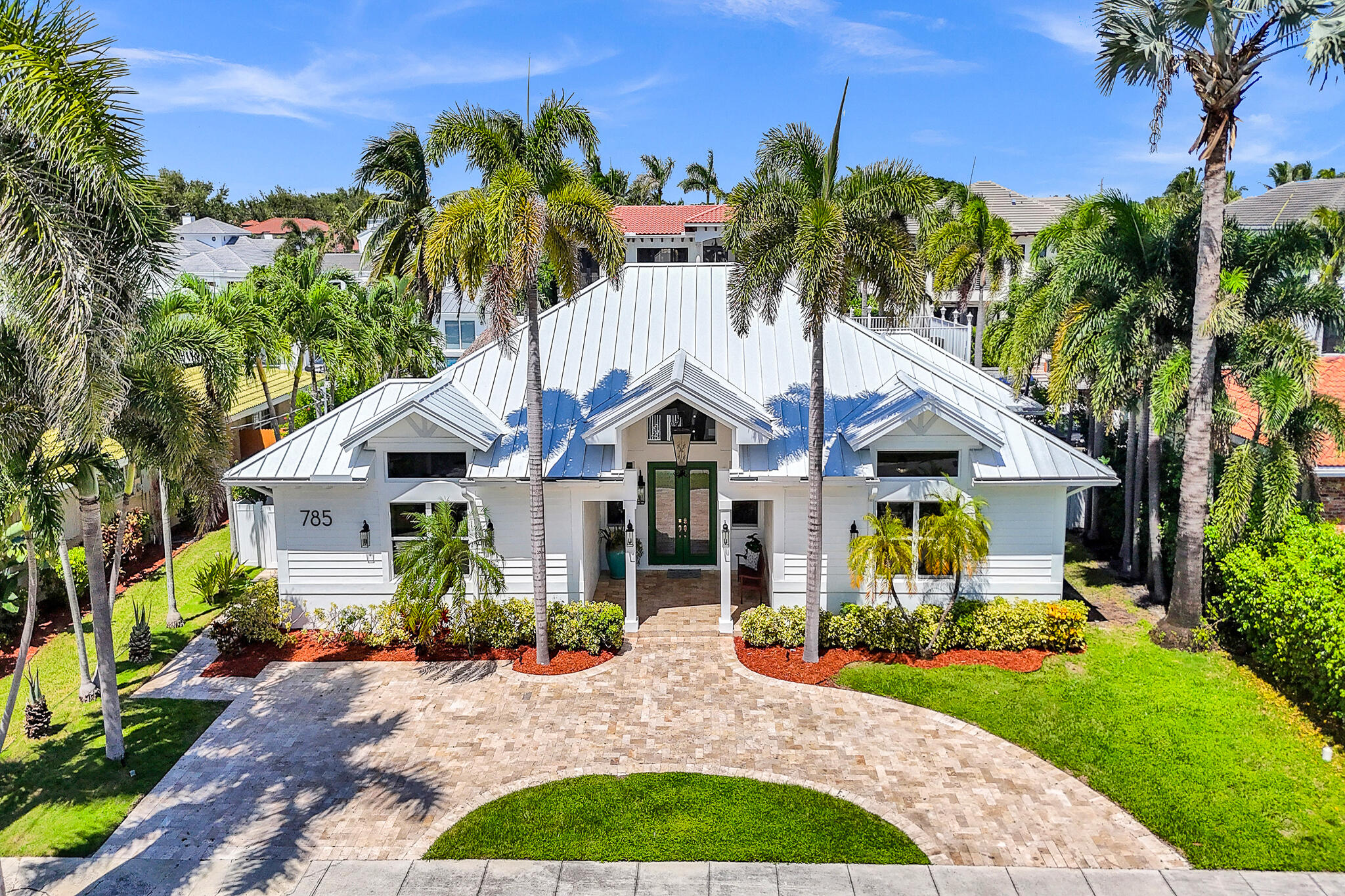 785 Northeast 71st Street Boca Raton, FL 33487 - Photo 58 of 62 a front view of a house with garden