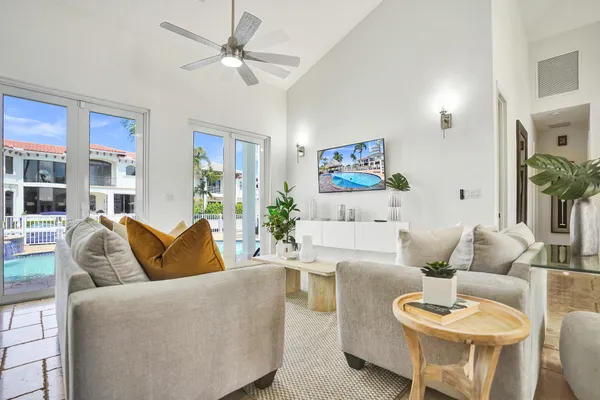 a living room with kitchen island furniture and a chandelier