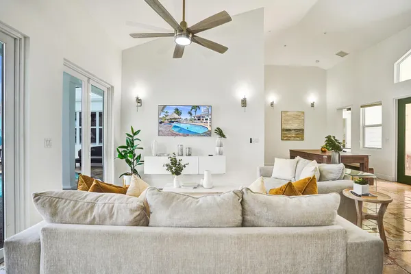 a view of a dining room with furniture and a potted plant