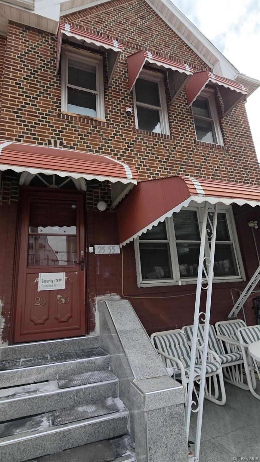 25-55 97th Street Queens, NY 11369 - Photo 14 of 15 a front view of a house with entryway