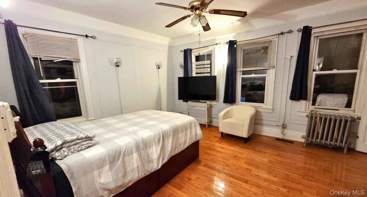 25-55 97th Street Queens, NY 11369 - Photo 6 of 15 a bedroom with a bed and a flat screen tv