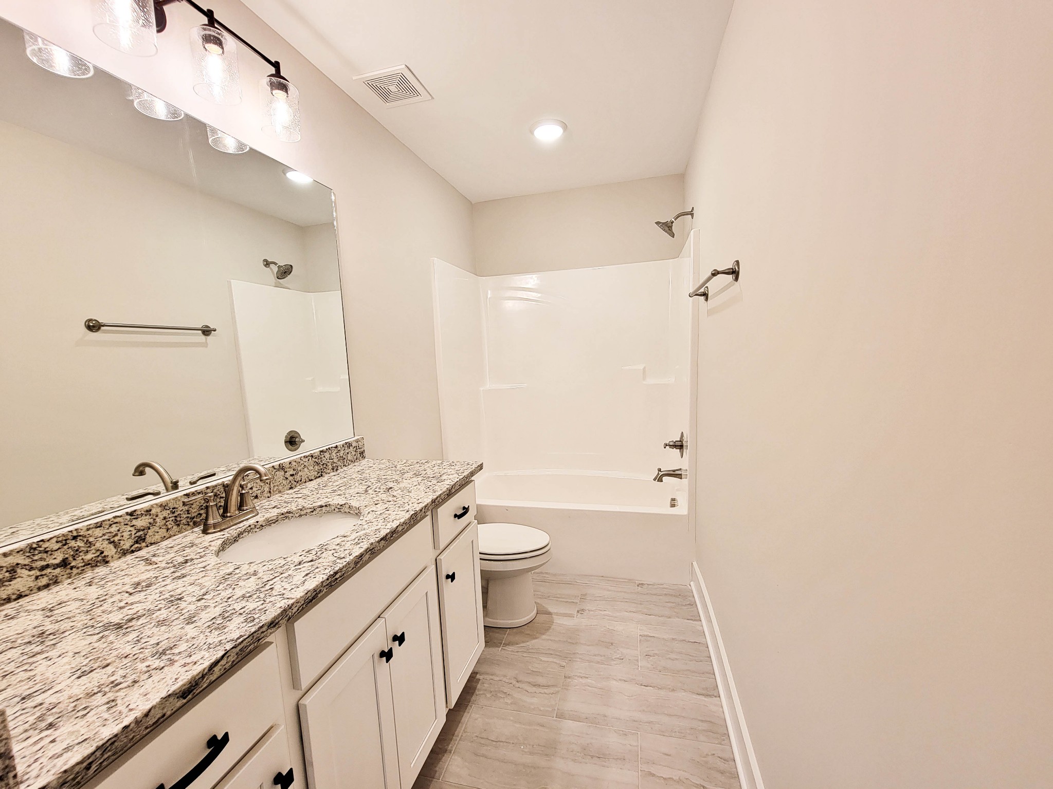 1581 Harrison Road Murfreesboro, TN 37128 - Photo 20 of 25 a bathroom with a granite countertop sink a toilet and a shower