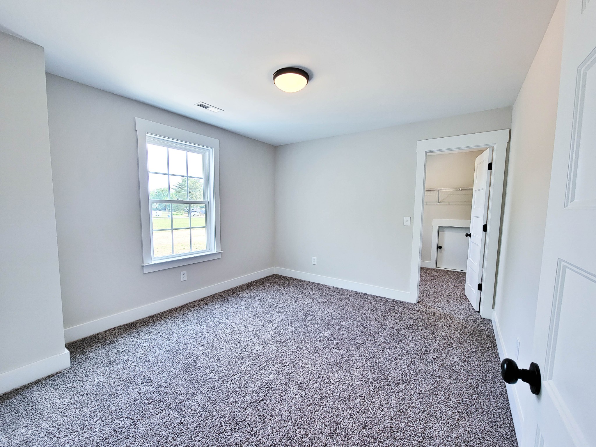 1581 Harrison Road Murfreesboro, TN 37128 - Photo 22 of 25 an empty room with a window and a carpet