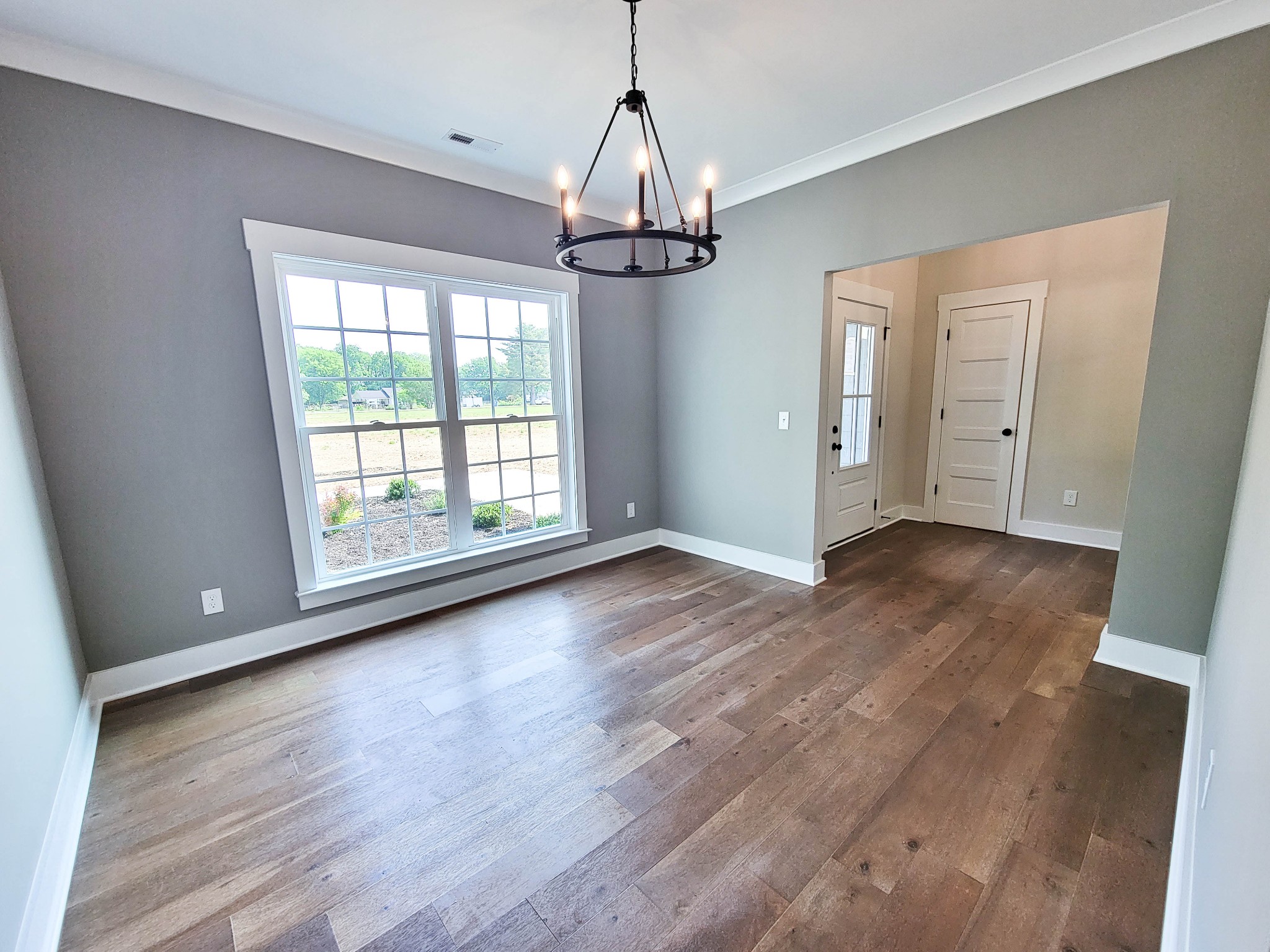1581 Harrison Road Murfreesboro, TN 37128 - Photo 7 of 25 a view of a room with wooden floor chandelier and windows