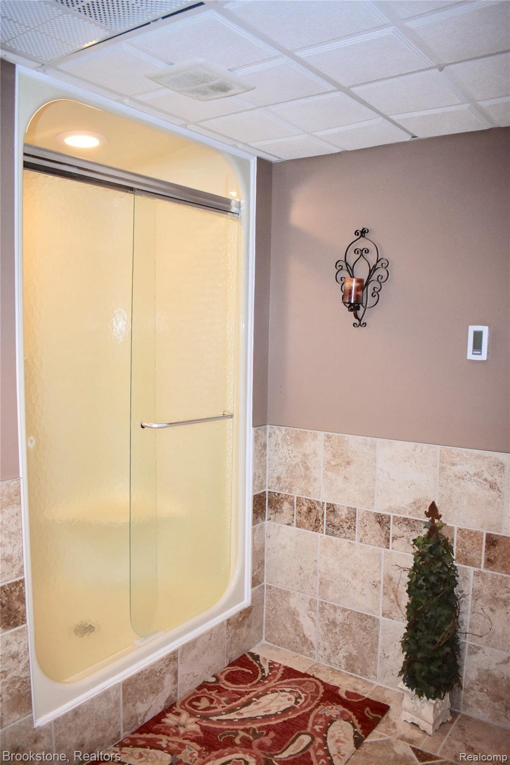 405 Baldwin Ridge Oxford, MI 48371 - Photo 53 of 54 THIS IS THE LARGE SHOWER IN THE FINISHED WALK-OUT BASEMENT BATHROOM (8X10). THE CERAMIC FLOOR IS HEATED. THANK YOU FOR TOURING THIS LARGE "CUSTOM" RANCH STYLE HOUSE (4,296 FINISHED SQ FT) THAT WAS TRULLY "DESIGNED FOR ENTERTAINING"