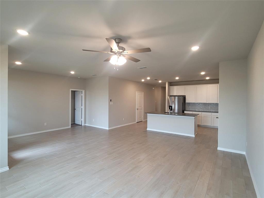 933 Ravenwood Lane Van Alstyne, TX 75495 - Photo 2 of 10 a view of kitchen with kitchen island stainless steel appliances a sink and a refrigerator