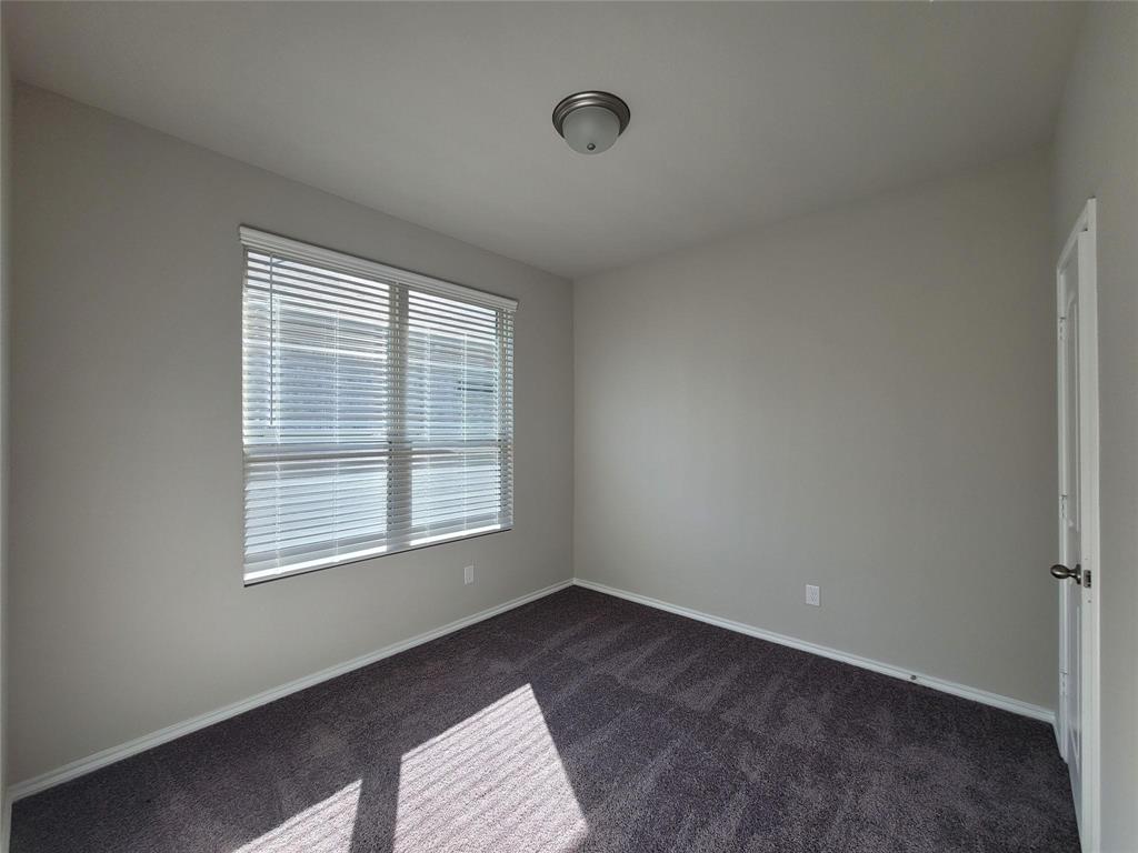 933 Ravenwood Lane Van Alstyne, TX 75495 - Photo 7 of 10 a view of an empty room with a window