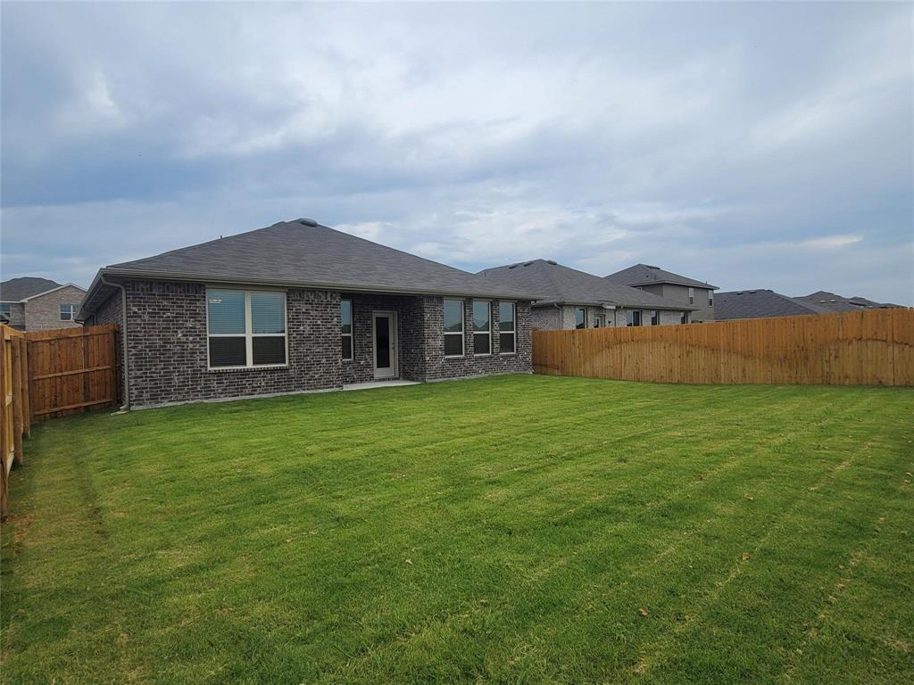 933 Ravenwood Lane Van Alstyne, TX 75495 - Photo 10 of 10 a front view of a house with a garden