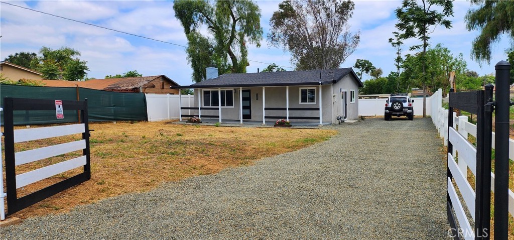 a view of a house with a yard and sitting area