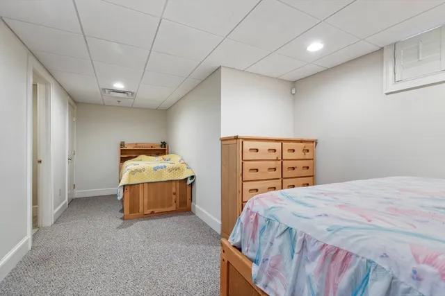 a bedroom with a bed and dresser