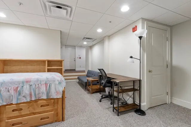 a bedroom with a bed a table and chair