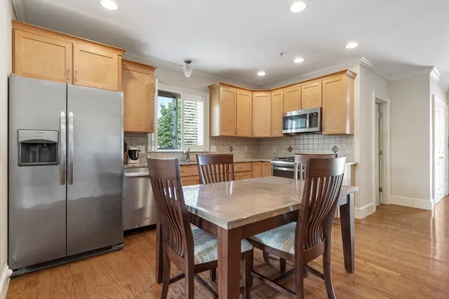 a kitchen with kitchen island a refrigerator stove microwave and cabinets