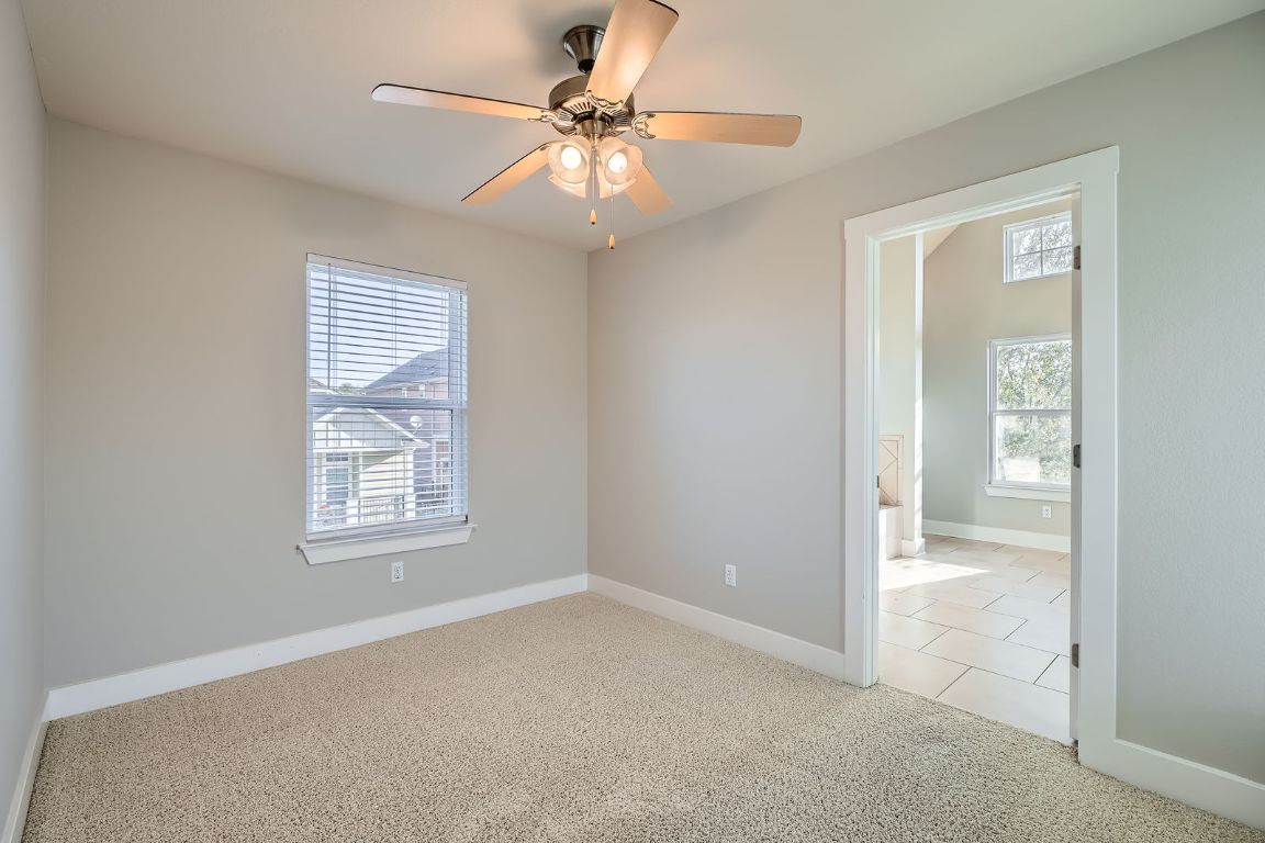 12200 Barras Branch Drive, Unit 135 Austin, TX 78748 - Photo 18 of 31 an empty room with windows and fan