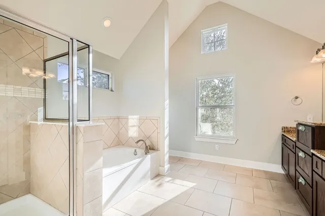 a bathroom with a bathtub and a shower