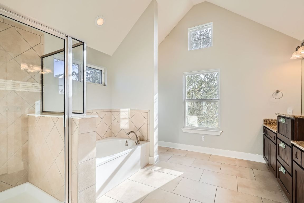12200 Barras Branch Drive, Unit 135 Austin, TX 78748 - Photo 20 of 31 a bathroom with a bathtub and a shower