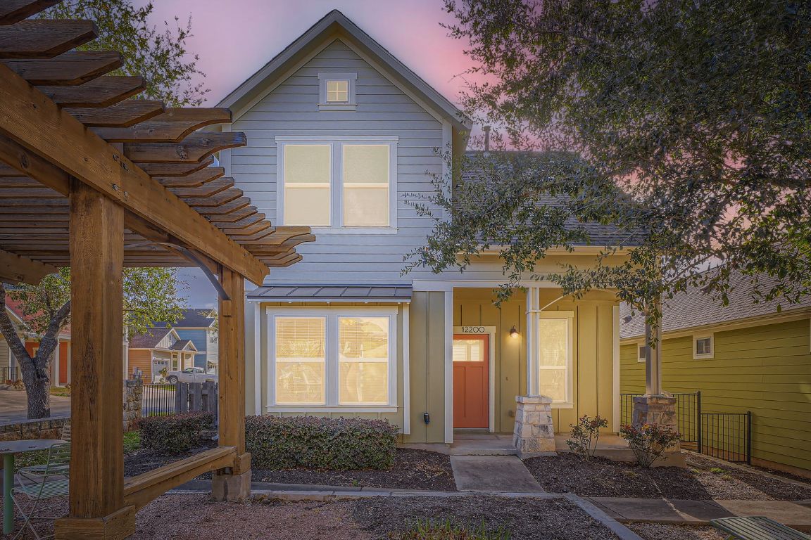 12200 Barras Branch Drive, Unit 135 Austin, TX 78748 - Photo 2 of 31 a front view of a house with a yard