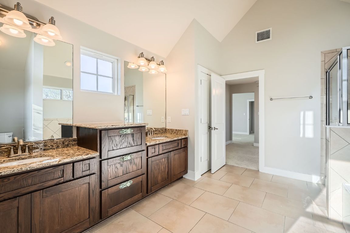 12200 Barras Branch Drive, Unit 135 Austin, TX 78748 - Photo 21 of 31 a kitchen with stainless steel appliances granite countertop a refrigerator and a sink