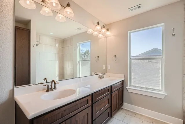 a bathroom with a sink double vanity and a mirror