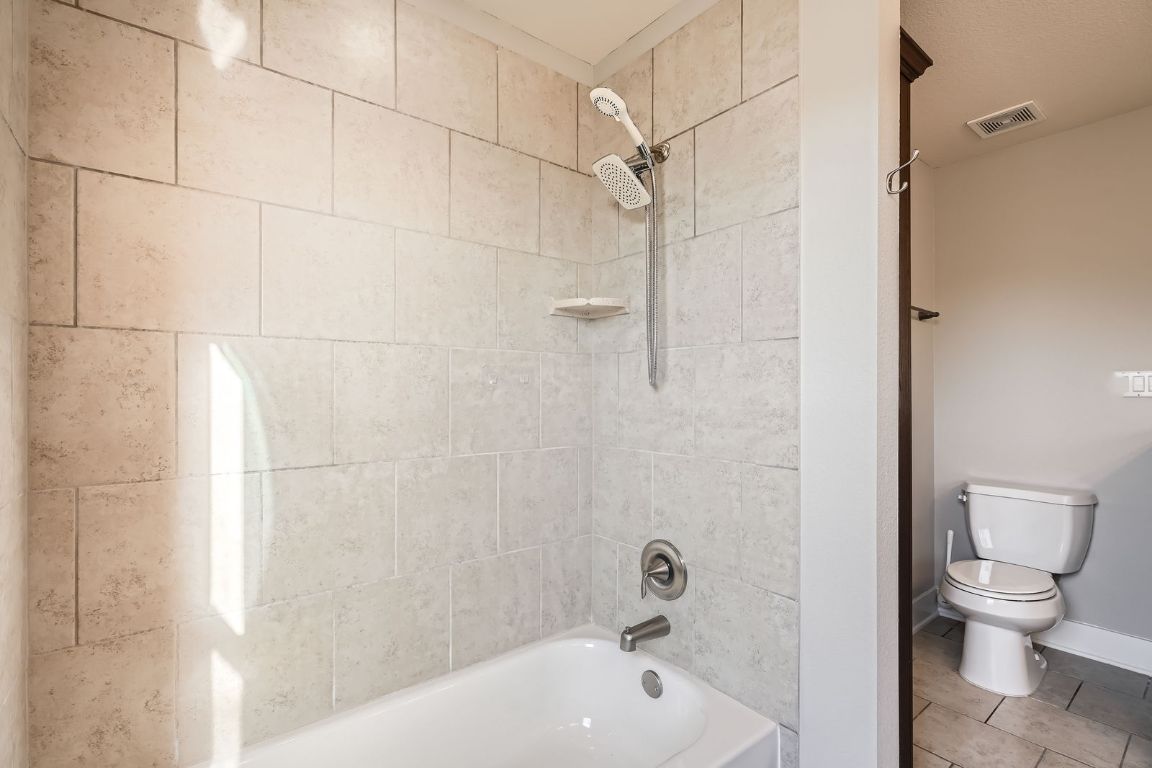 12200 Barras Branch Drive, Unit 135 Austin, TX 78748 - Photo 25 of 31 a bathroom with a bathtub and a toilet