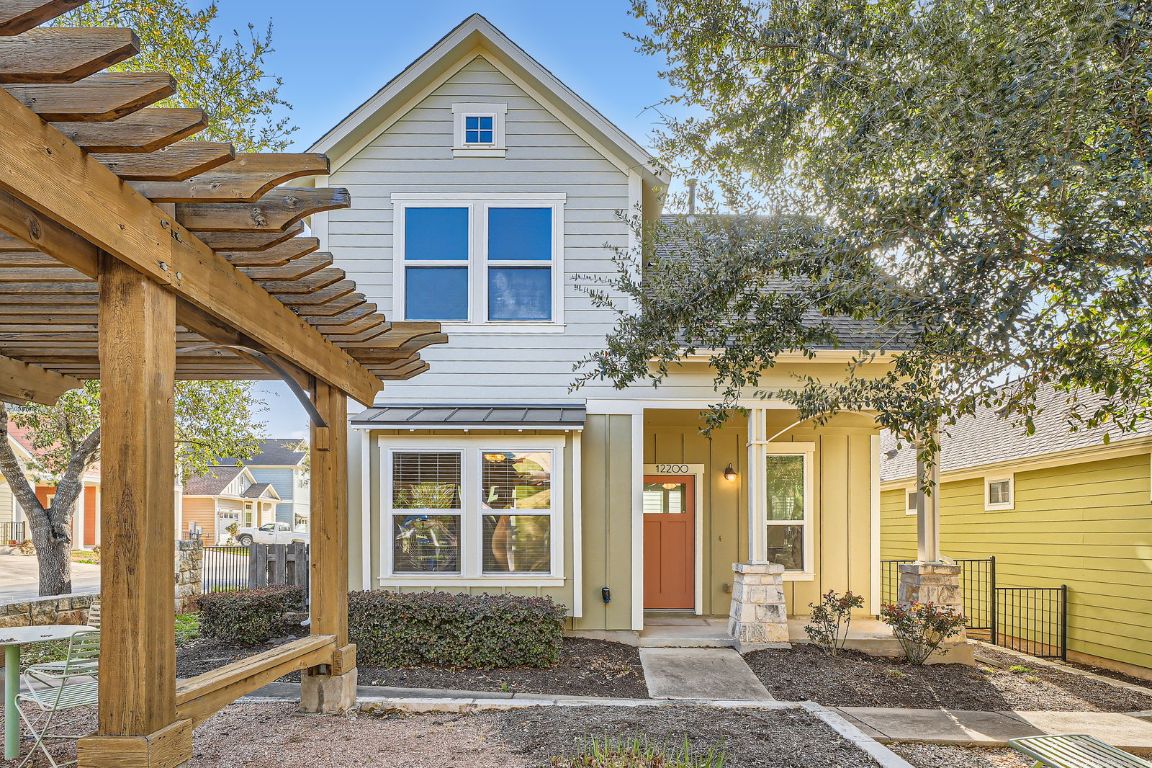 12200 Barras Branch Drive, Unit 135 Austin, TX 78748 - Photo 3 of 31 a front view of a house with a yard