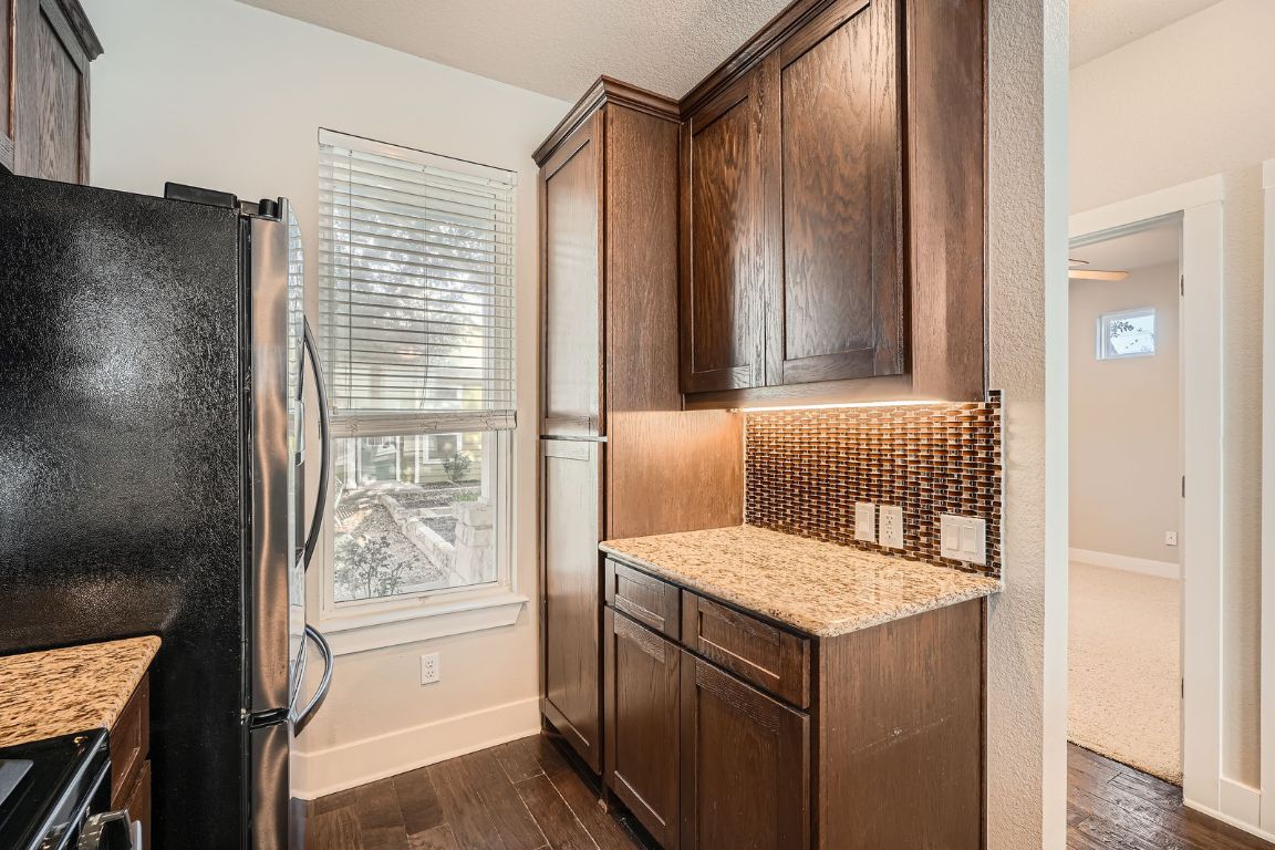 12200 Barras Branch Drive, Unit 135 Austin, TX 78748 - Photo 10 of 31 a bathroom with a granite countertop sink and a mirror