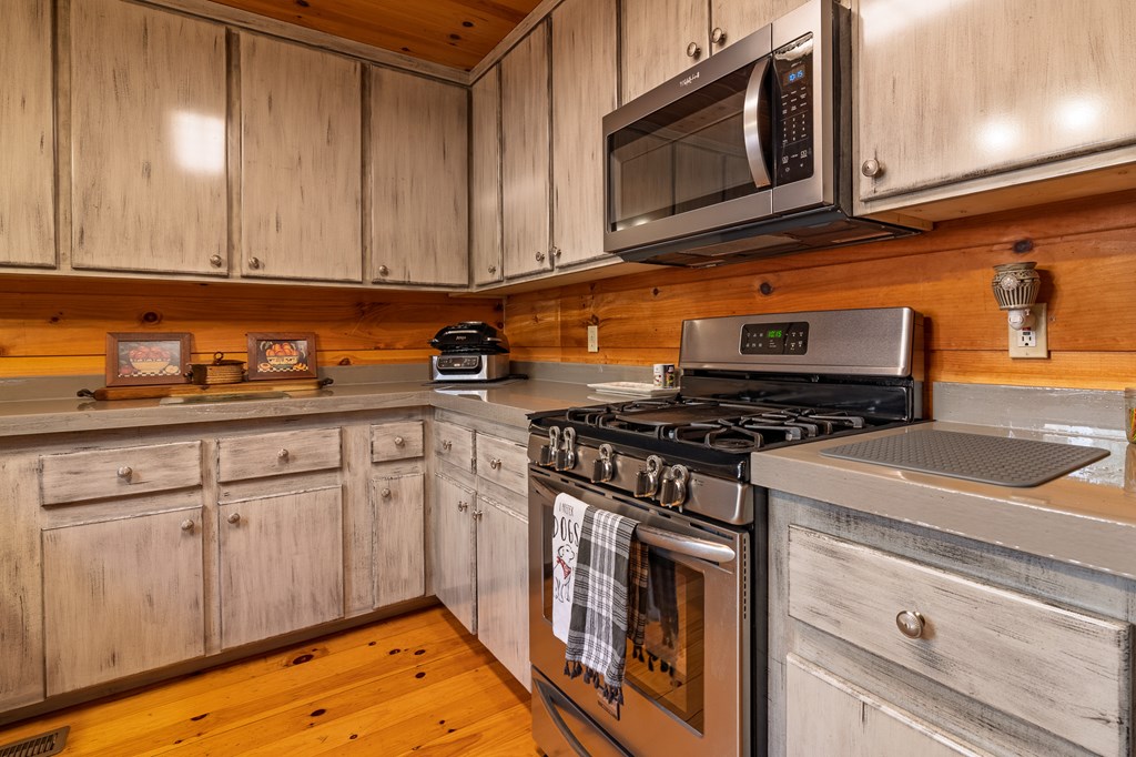 659 Kells Ridge Drive Ellijay, GA 30540 - Photo 11 of 41 a kitchen with stainless steel appliances granite countertop a stove and a microwave