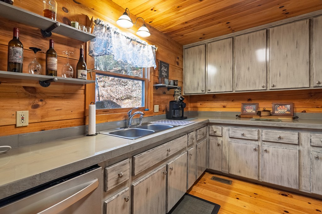 659 Kells Ridge Drive Ellijay, GA 30540 - Photo 12 of 41 a kitchen with stainless steel appliances granite countertop a sink a stove and cabinets