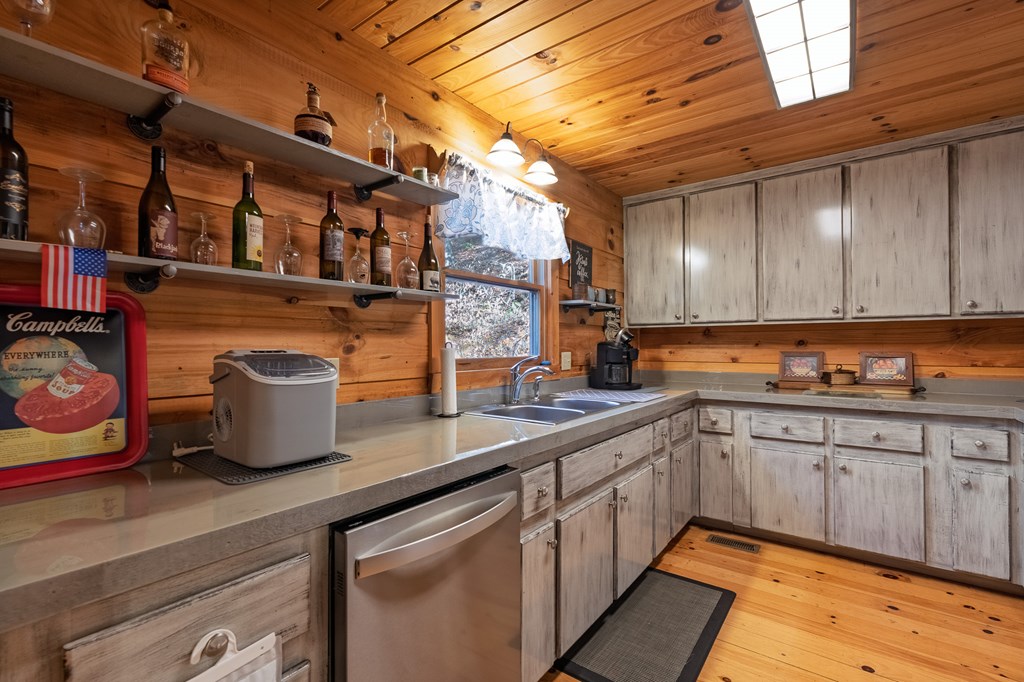 659 Kells Ridge Drive Ellijay, GA 30540 - Photo 13 of 41 a kitchen with stainless steel appliances granite countertop a sink a stove and cabinets
