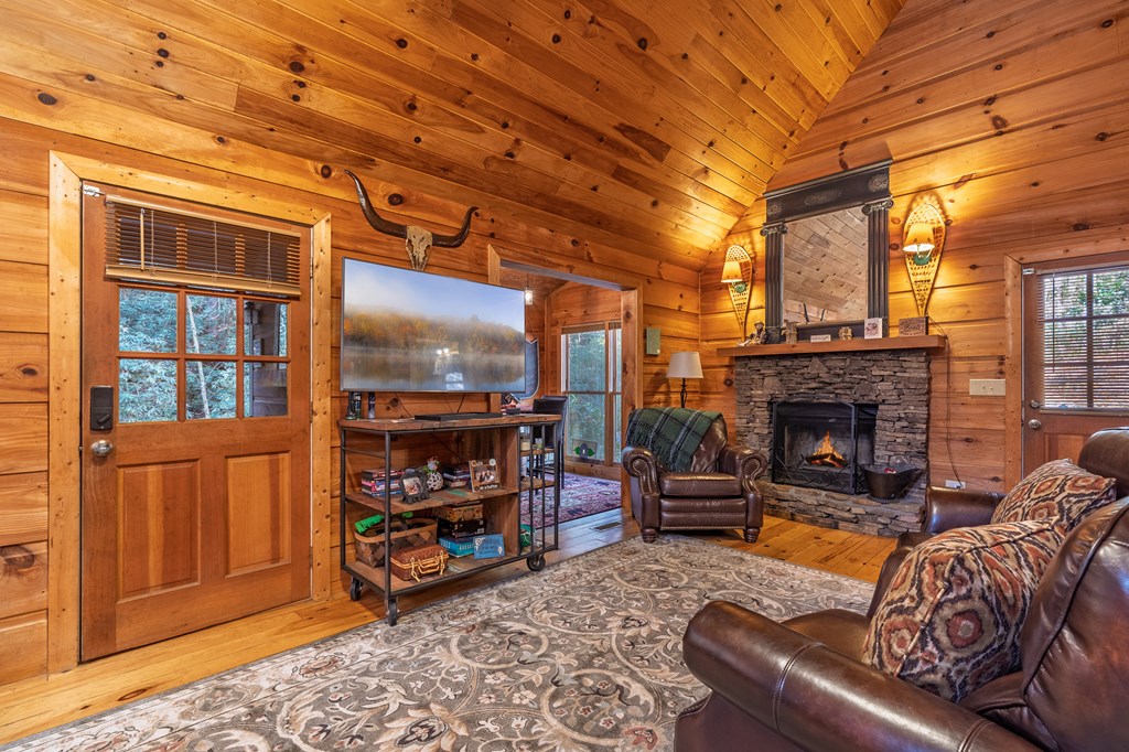 659 Kells Ridge Drive Ellijay, GA 30540 - Photo 15 of 41 a living room with furniture a fireplace and a window