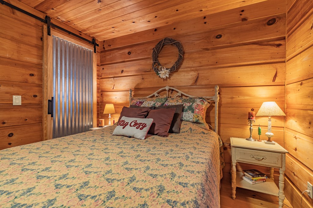 659 Kells Ridge Drive Ellijay, GA 30540 - Photo 27 of 41 a bedroom with a bed and a dresser