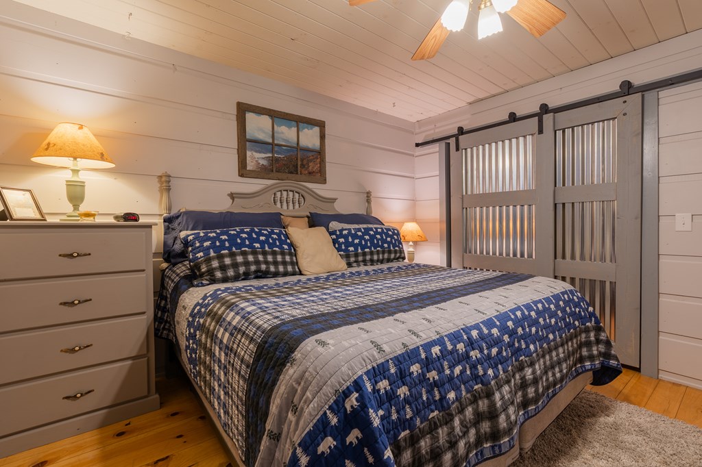 659 Kells Ridge Drive Ellijay, GA 30540 - Photo 32 of 41 a bedroom with a large bed and a dresser