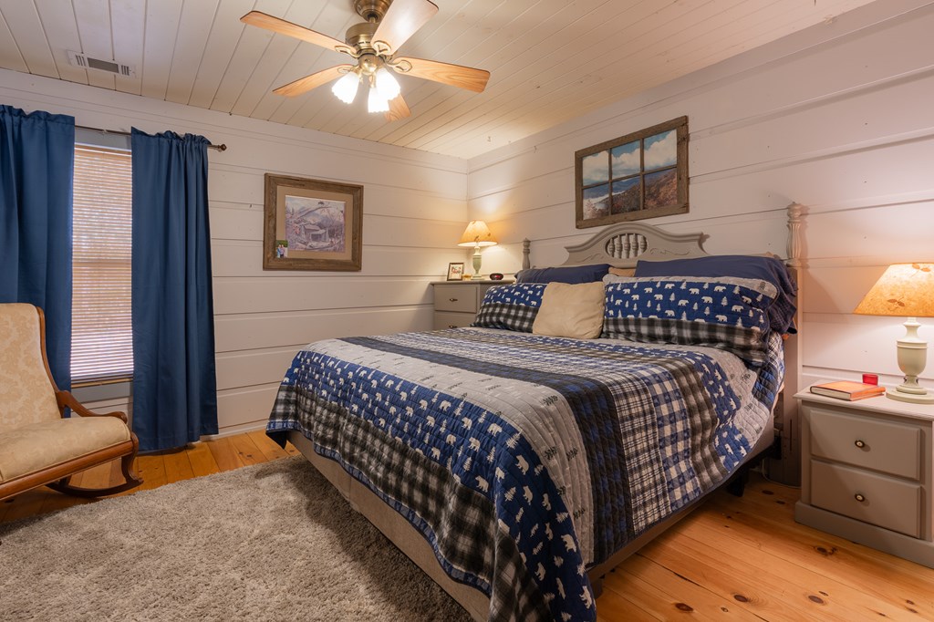 659 Kells Ridge Drive Ellijay, GA 30540 - Photo 33 of 41 a bedroom with a bed and a chandelier