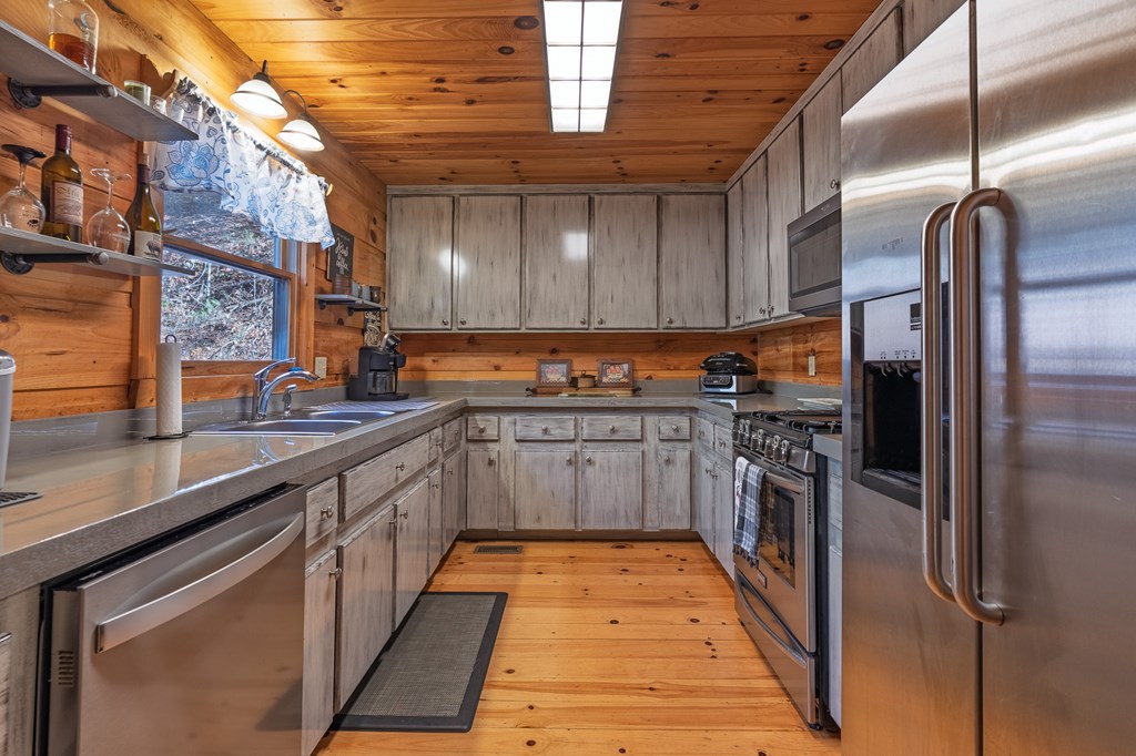 659 Kells Ridge Drive Ellijay, GA 30540 - Photo 10 of 41 a kitchen with stainless steel appliances granite countertop a refrigerator a sink and wooden cabinets