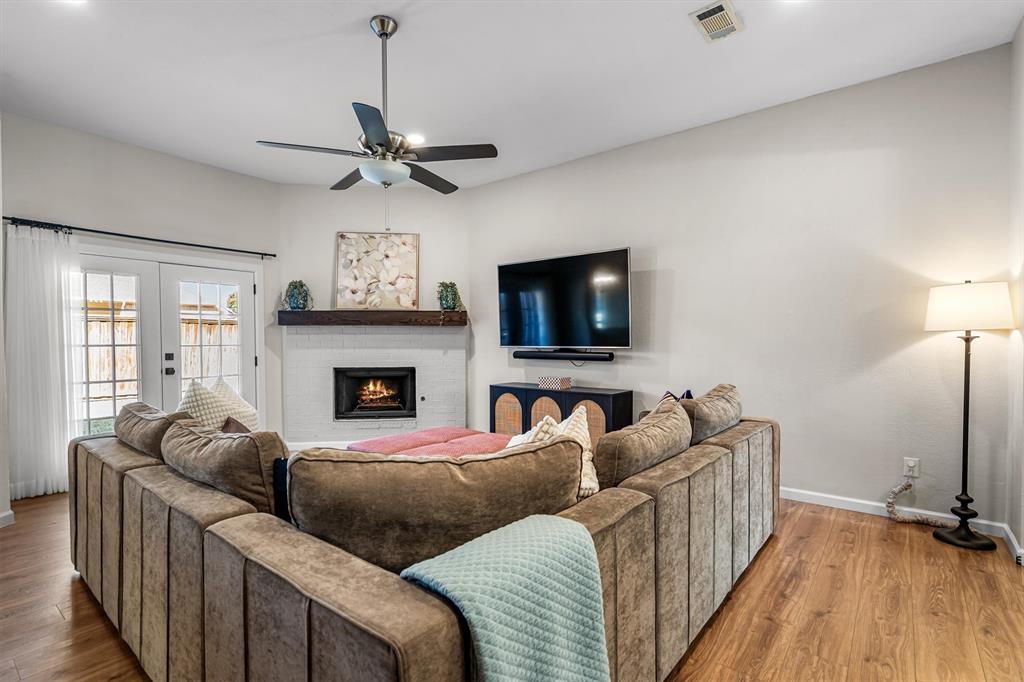 2113 Garner Court Rowlett, TX 75088 - Photo 11 of 40 a living room with furniture a flat screen tv and a fireplace