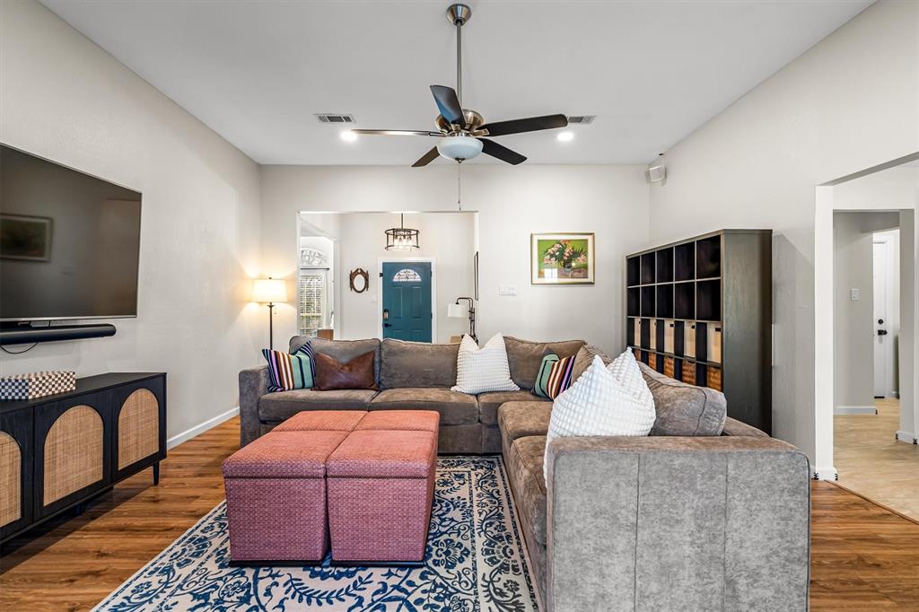 2113 Garner Court Rowlett, TX 75088 - Photo 13 of 40 a living room with furniture a flat screen tv and a fireplace