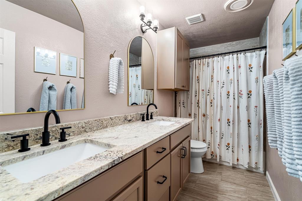 2113 Garner Court Rowlett, TX 75088 - Photo 22 of 40 a bathroom with a granite countertop sink and a mirror