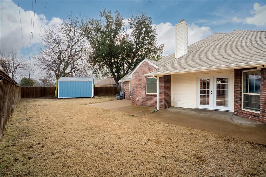 2113 Garner Court Rowlett, TX 75088 - Photo 26 of 40 a front view of a house with a yard and garage