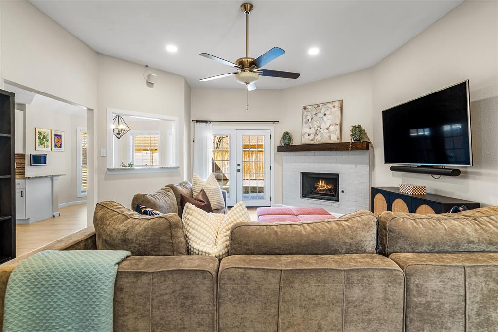 2113 Garner Court Rowlett, TX 75088 - Photo 10 of 40 a living room with furniture a flat screen tv and a fireplace