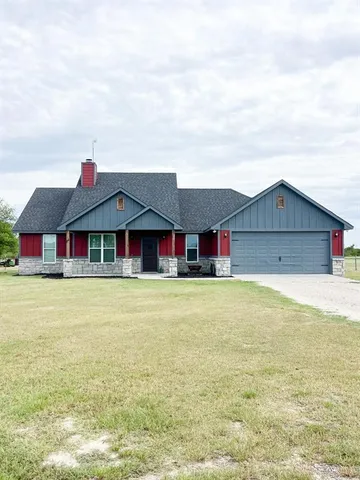 a aerial view of a house next to a big yard