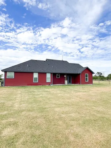 a view of a big yard with a small yard and a large tree