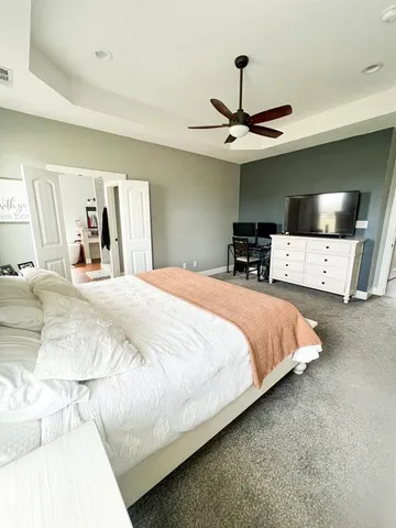 a kitchen with a sink and white cabinets with wooden floor