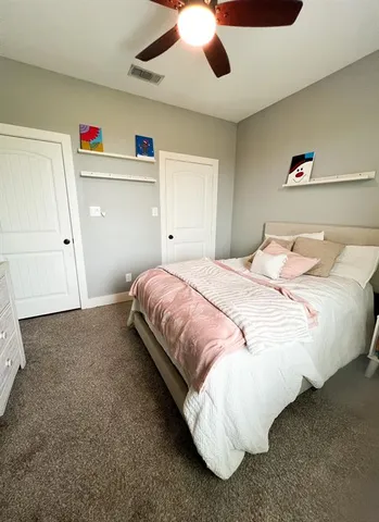 a spacious bedroom with a bed and a walk in closet