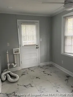 a view of a livingroom with furniture and a window