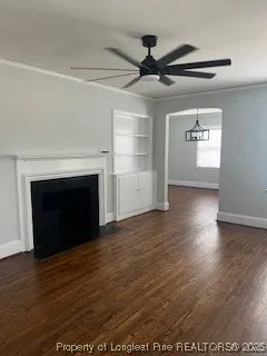 a view of empty room with wooden floor and fireplace
