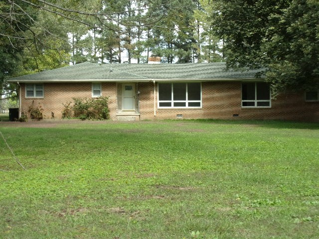 3231 State Line Road Taft, TN 38488 - Photo 1 of 26 a front view of a house with a garden